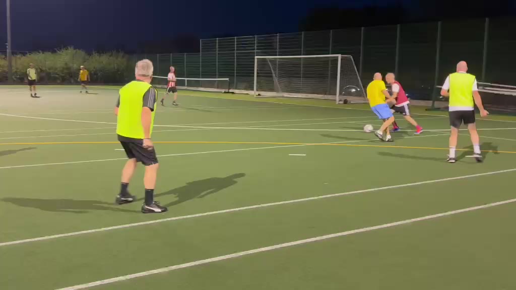 Over 50s football match action in Brackley